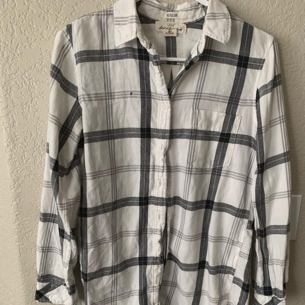 A black and white flannel button up shirt.